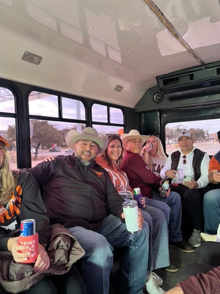 A crew in burnt orange and cowboy hats on a game day